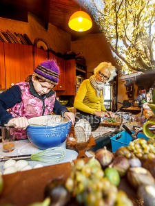 Lois Mills, matriarch/founder of Rippon (with husband Rolfe), feeds everyone during harvest from rammed earth home built by Rolfe. Grand daughter Harriet helping, Rippon, Wanaka, Queenstown Lakes (54367QF00)