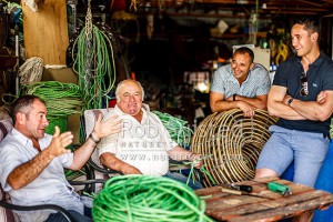 Tony Muollo, with father Carlo, brother Dion and nephew Josh, share a laugh while working on fishing equipment. All involved with the fishing industry, Wellington, Wellington City (54434QF00)